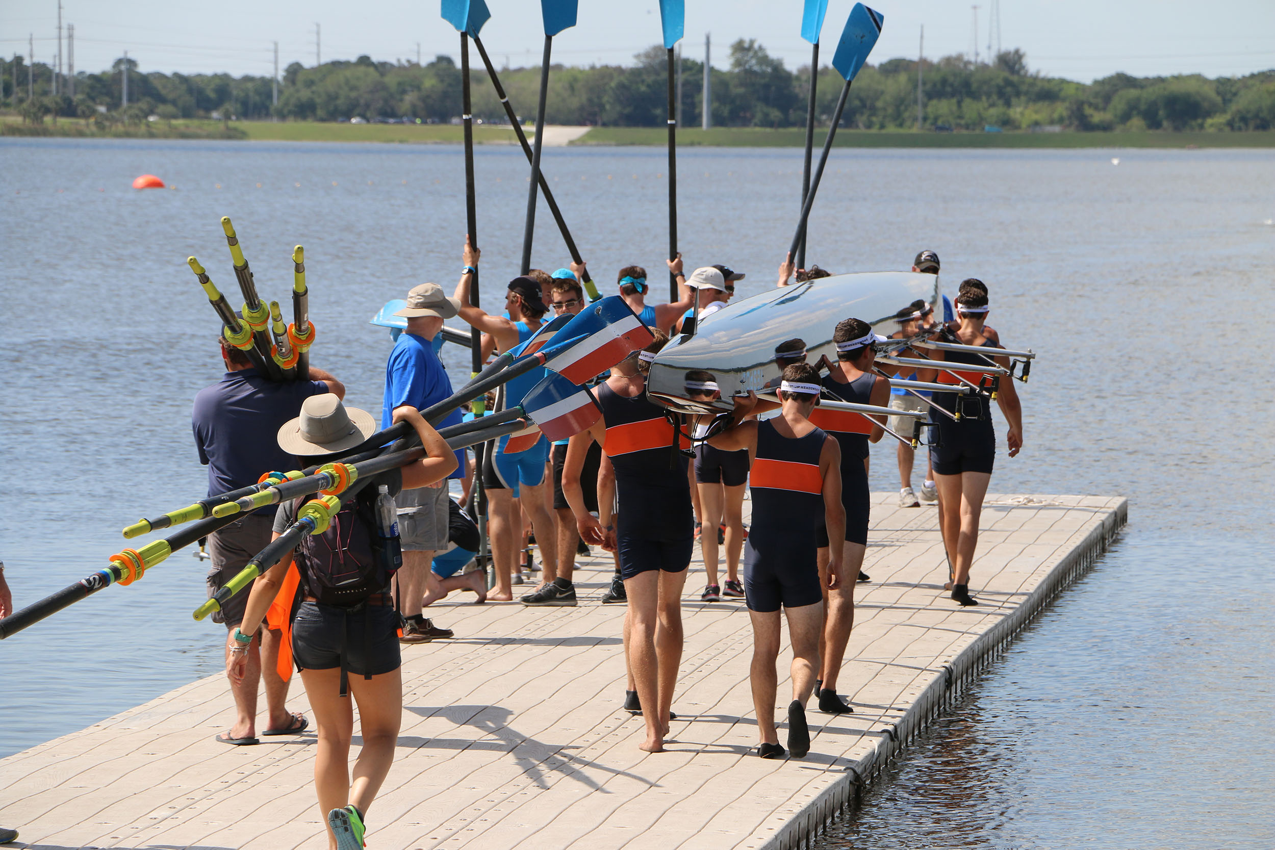 Rowing regatta teams bring their boats to a river for practice.