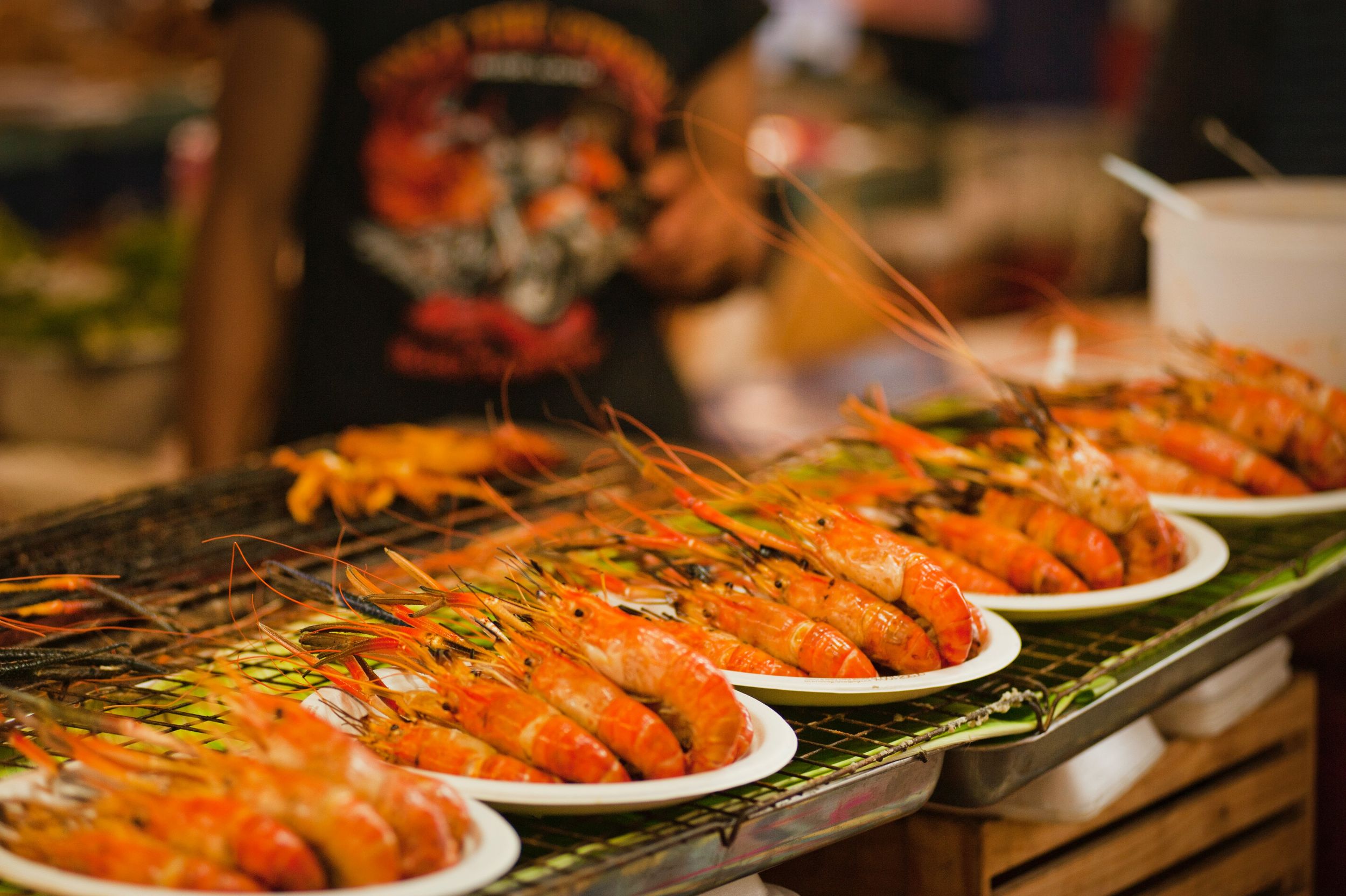 Plates of cooked shrimp at Seafood booth.