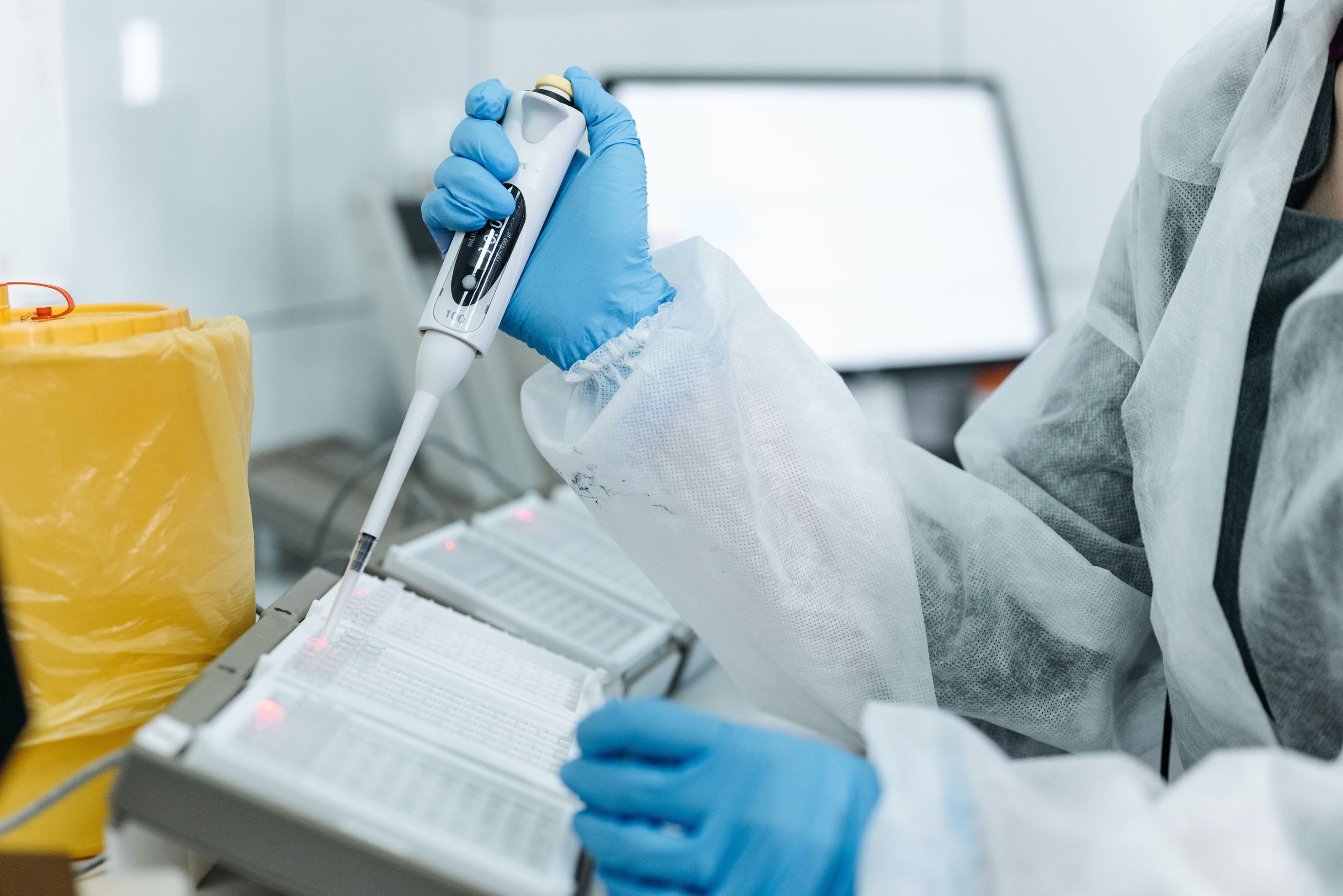 Scientist distributes samples in lab.