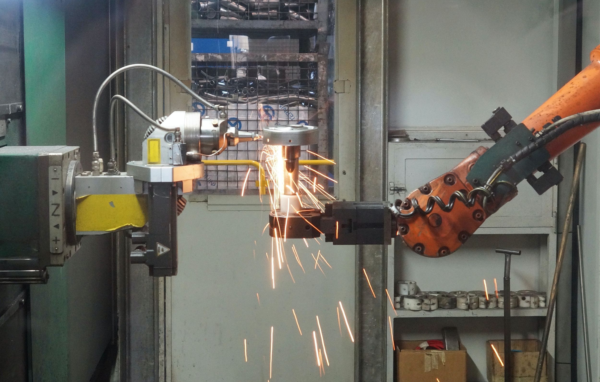An industrial robot machine grinding steel.