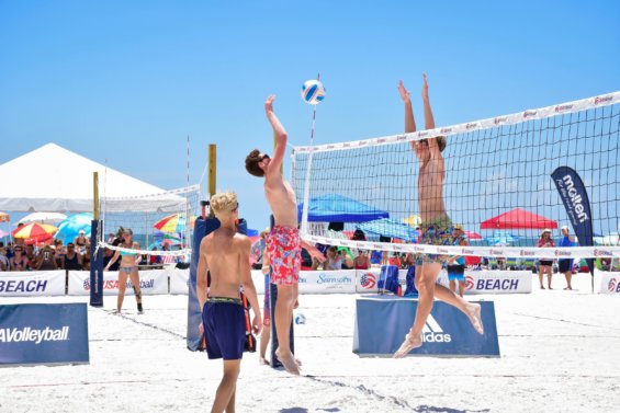 Two people play volleyball in the USA Volleyball Siesta Key championships.