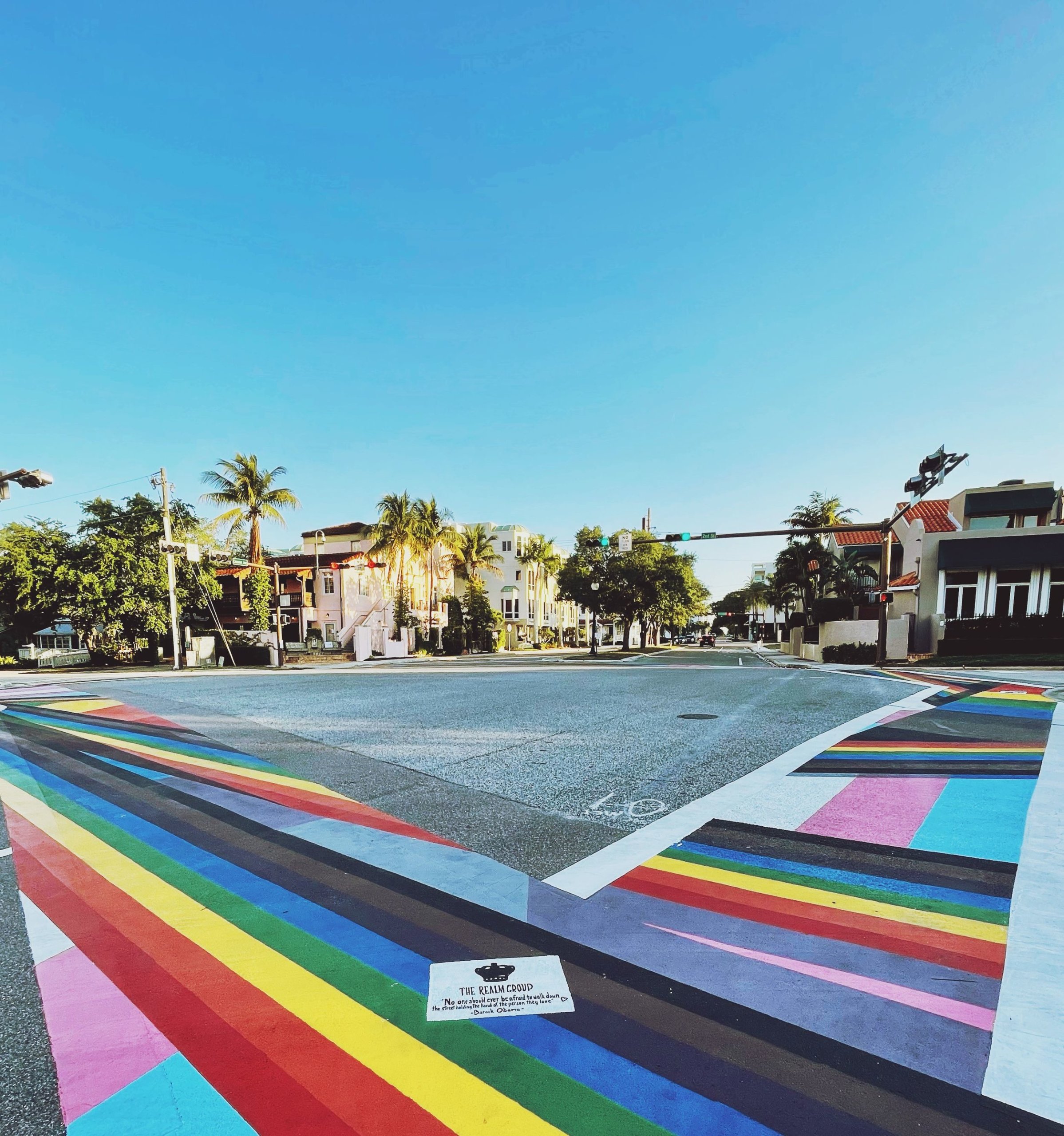 Street crosswalks painted as various pride flags.