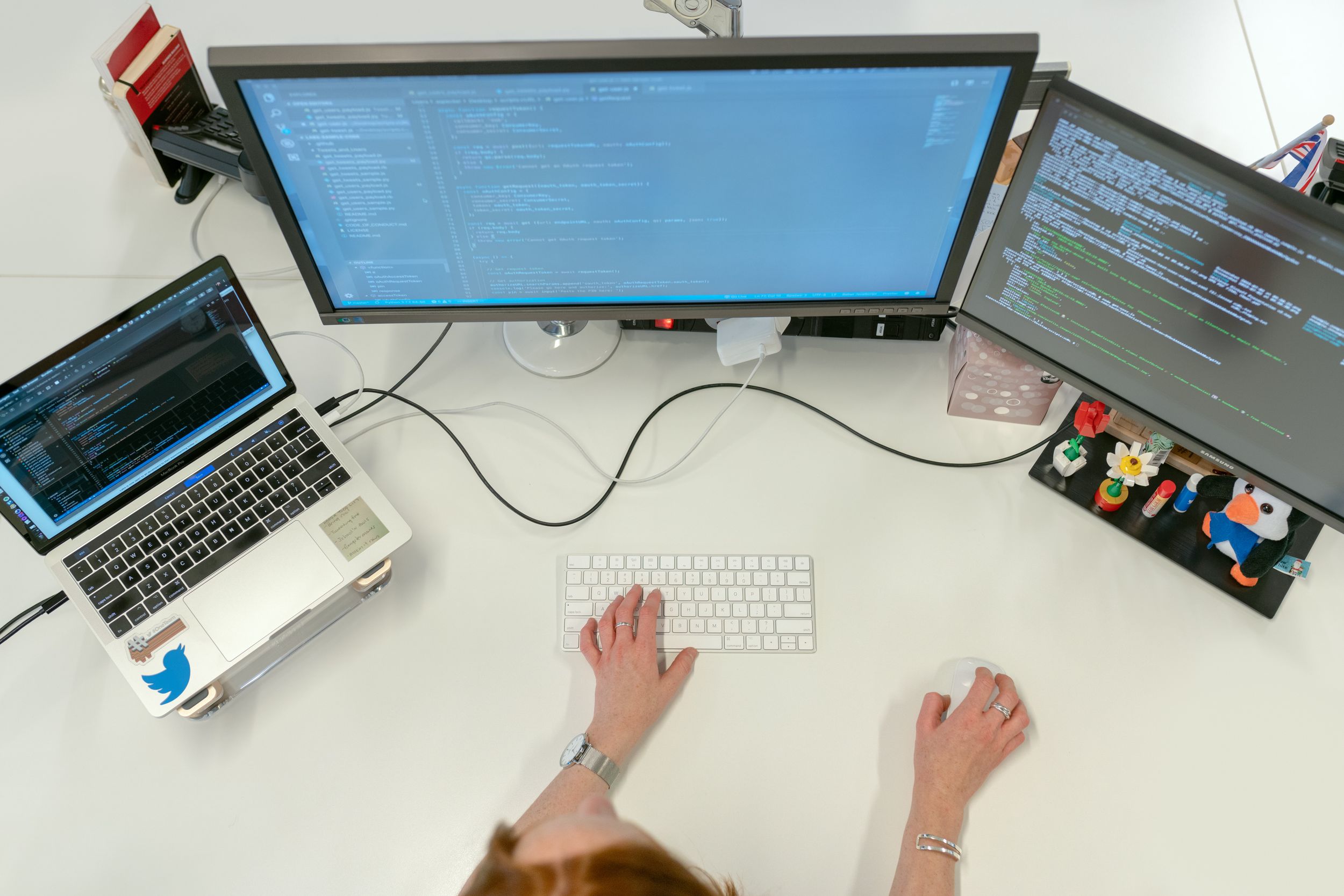 Female software engineer coding on computer technology.