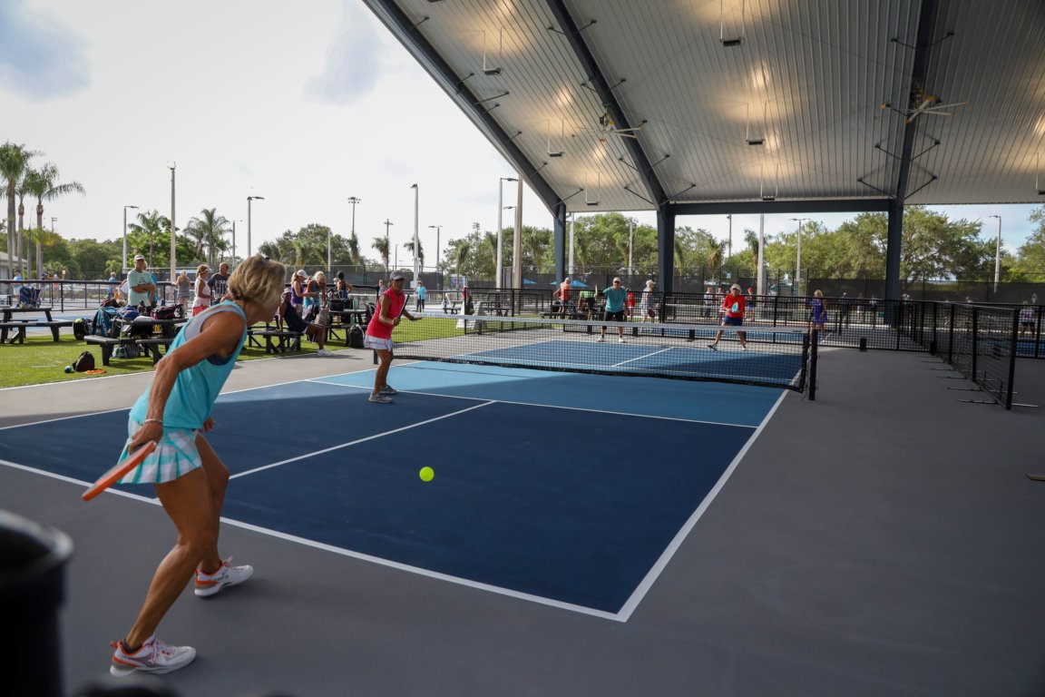 People play pickle ball at community courts in Bradenton.